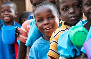 Children waiting in line to receive their school meal. 