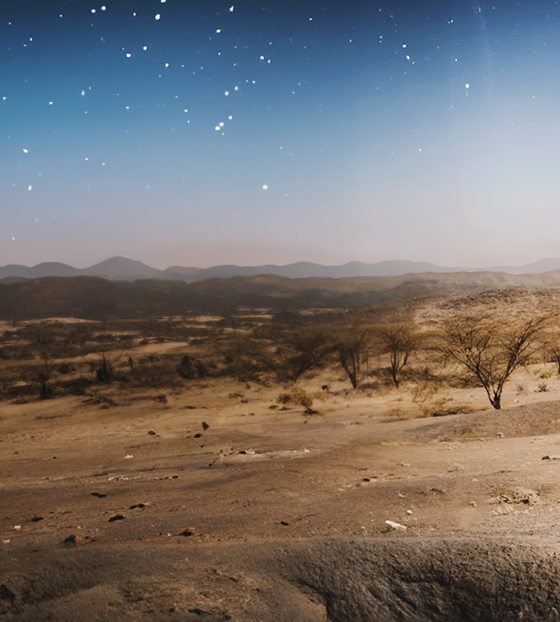 Image of a father and child walking against a desert backdrop in Turkana.