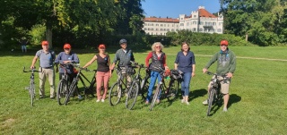 group of cyclists standing in a line on their bikes