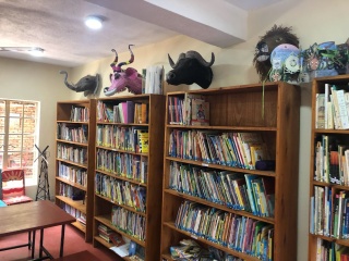 Image of a bookcase from the library with books lining the shelves.