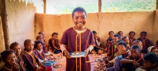 a child with a bowl of food