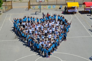 Mary's Meals supporters standing together to form a giant heart.