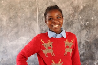 Image of a child wearing a Christmas Jumper. 