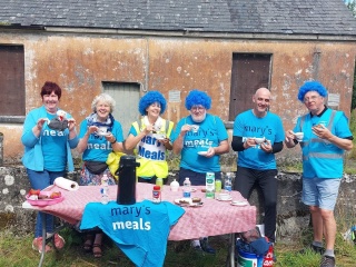 Mary's Meals supporters and staff at a stall in support of people making the Walk to Knock. 