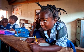 Image of a child in Zambia focussing in class. 